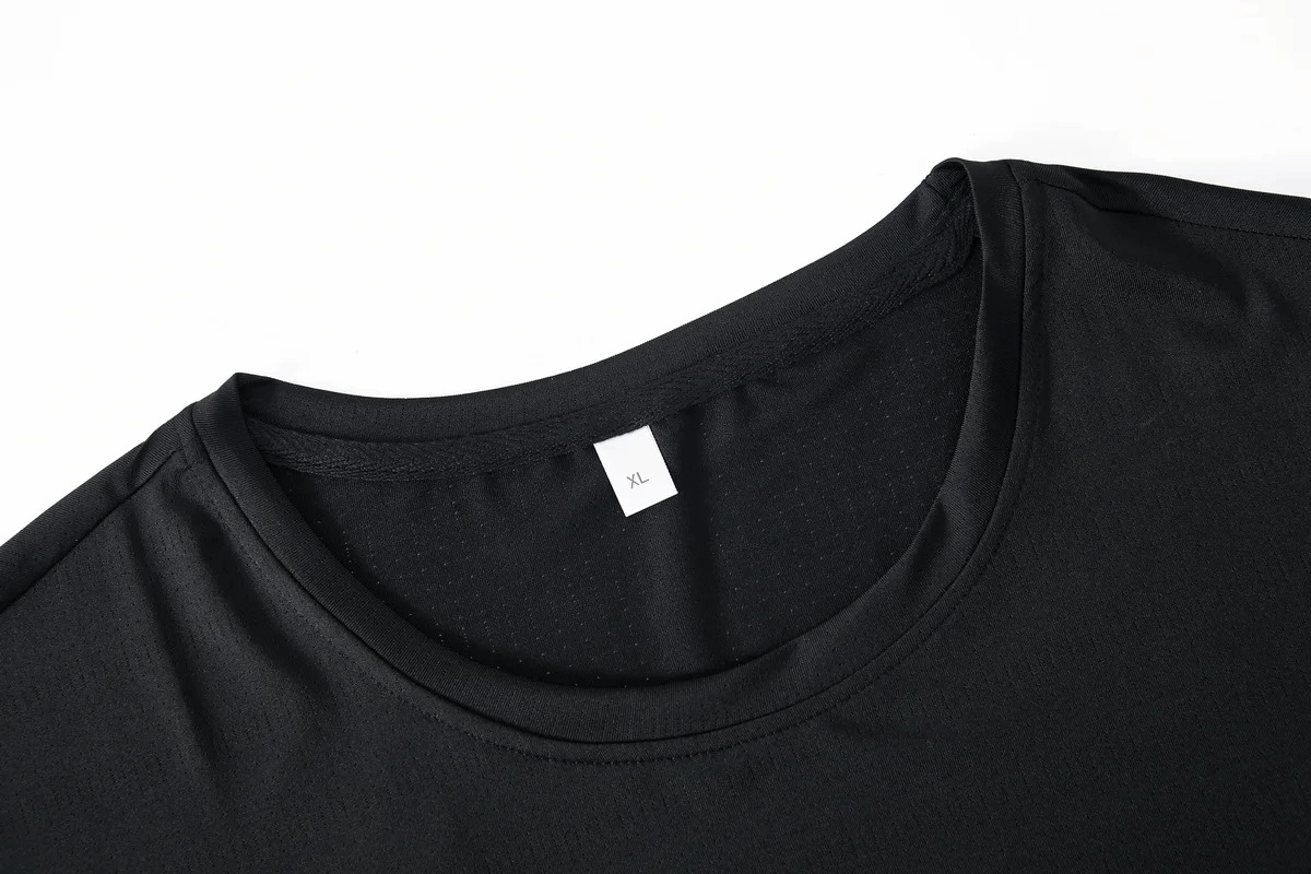 Close-up of black O-neck t-shirt in athletic wear set SF2033, showcasing breathable polyester fabric and XL size label.