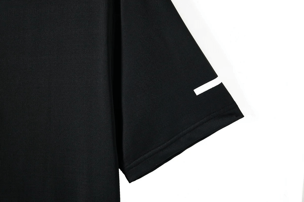 Close-up of Men's Black O-Neck T-Shirt sleeve, showcasing lightweight, flexible polyester fabric for athletic performance.