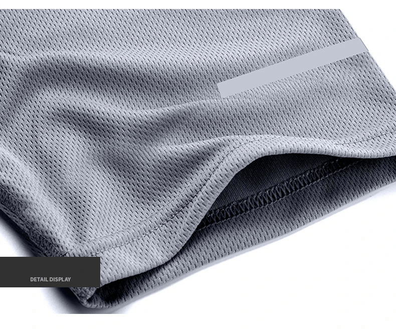 Close-up of gray breathable sportswear fabric showcasing meticulous stitching detail.