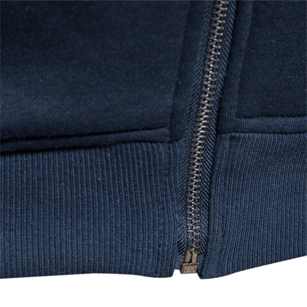 Close-up of navy ribbed hem and metallic zip on men's cotton blend sweatshirt, style SF2533, highlighting knit texture and construction.