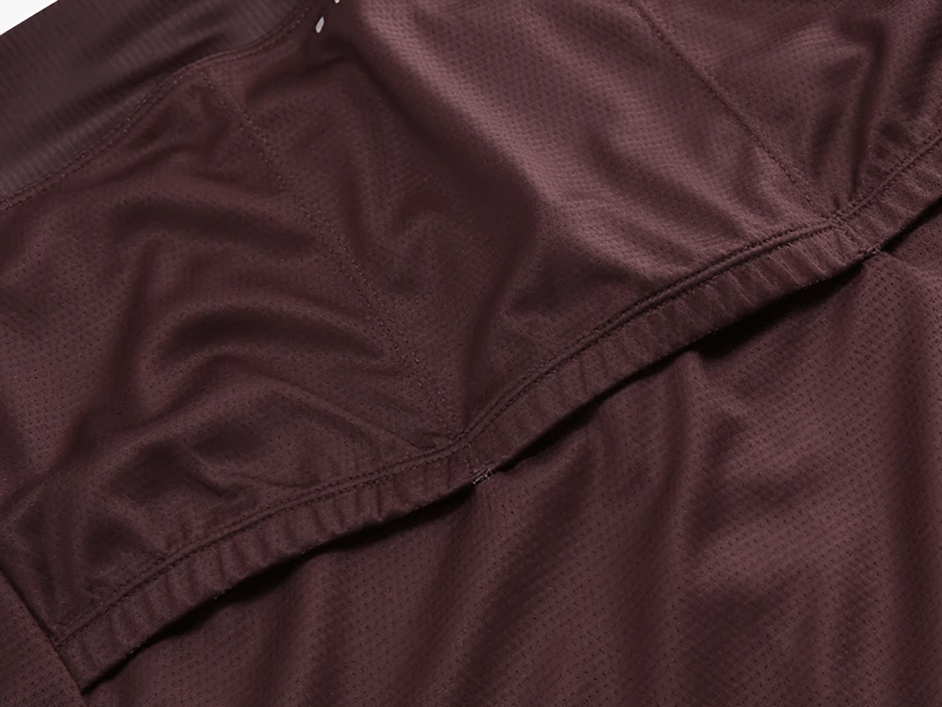 Close-up of SF2594 men's cycling jersey fabric in rich maroon, highlighting breathable texture for MTB and road bike racing.