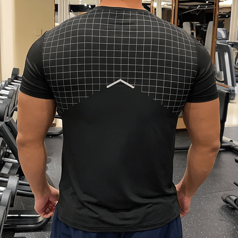 Back view of men's grid-print quick-dry gym tee by Fit Clothing, showcasing athletic fit and design in a gym setting.