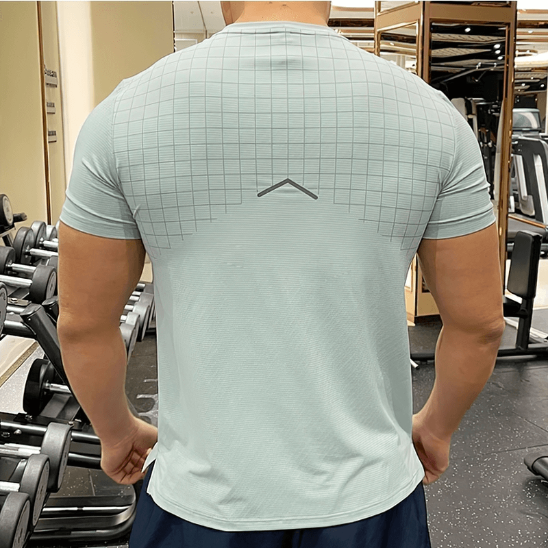 Man wearing Grid-Print Quick-Dry Gym Tee with O-neck, showcasing back design in a gym setting, perfect for intense workouts.