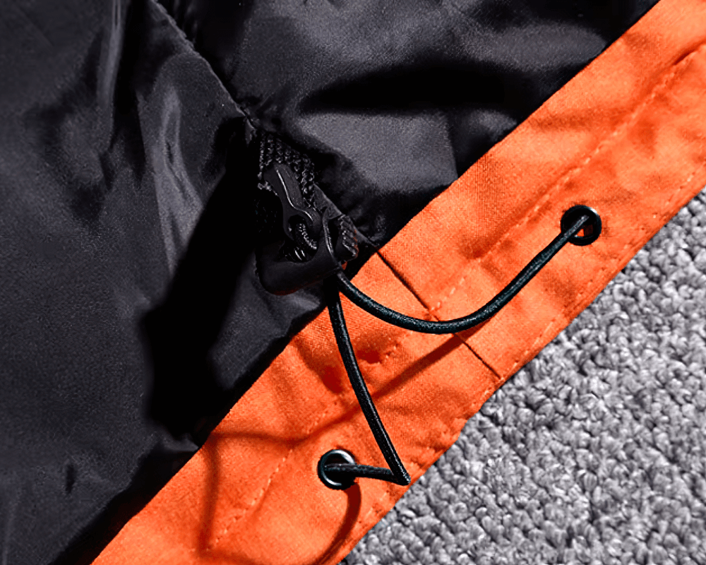 Close-up of black and orange hooded parka featuring durable drawstring details for adjustable fit and extra warmth.