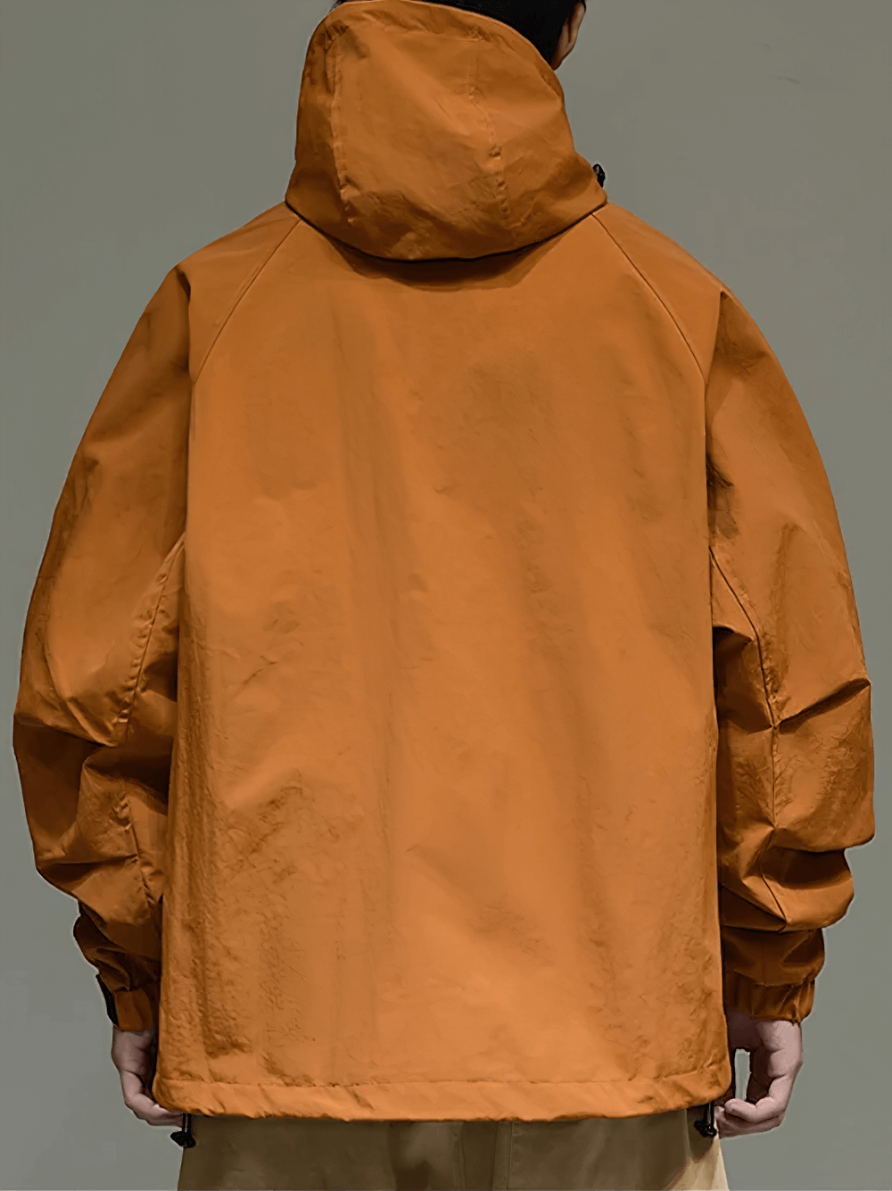 Alt Tag: Stylish men's orange hooded utility jacket with multi-pocket design, perfect for outdoor activities and streetwear fashion.