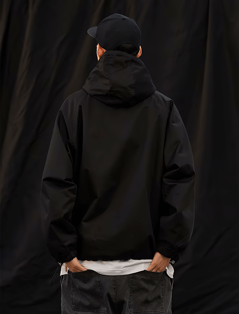 Man wearing black men's hooded pullover jacket, stylish streetwear fashion SF2271, half-zip and ribbed cuffs, rear view