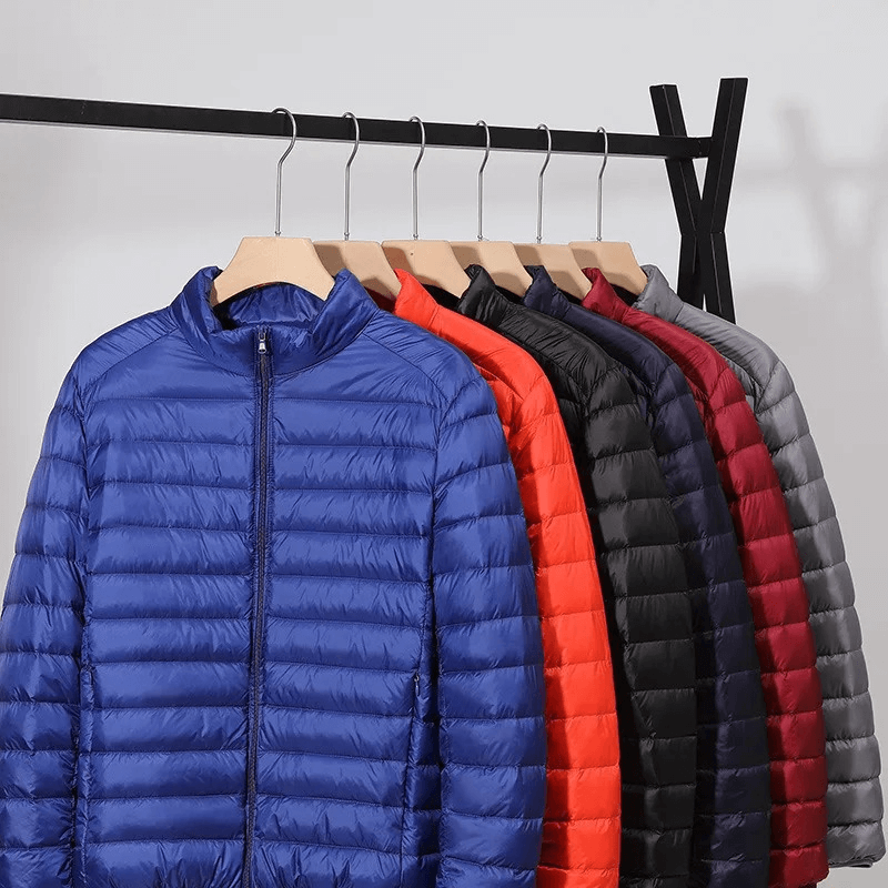 Men's insulated down jackets with stand collars in blue, red, black, and gray hanging on a rack, showcasing waterproof and windproof features.