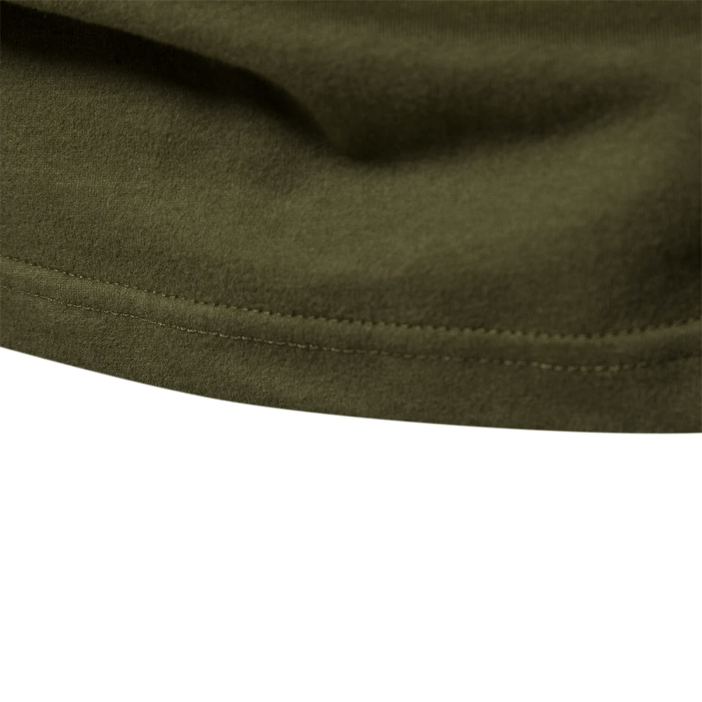 Close-up view of the soft, textured fabric of a men's long-sleeved patchwork cotton top in olive green.