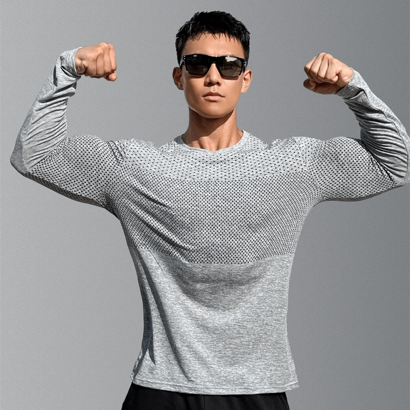 Man wearing Men's Long Sleeves Quick-Dry Workout Shirt SF1922, flexing muscles, showcasing breathable cotton blend fabric and quick-dry technology.