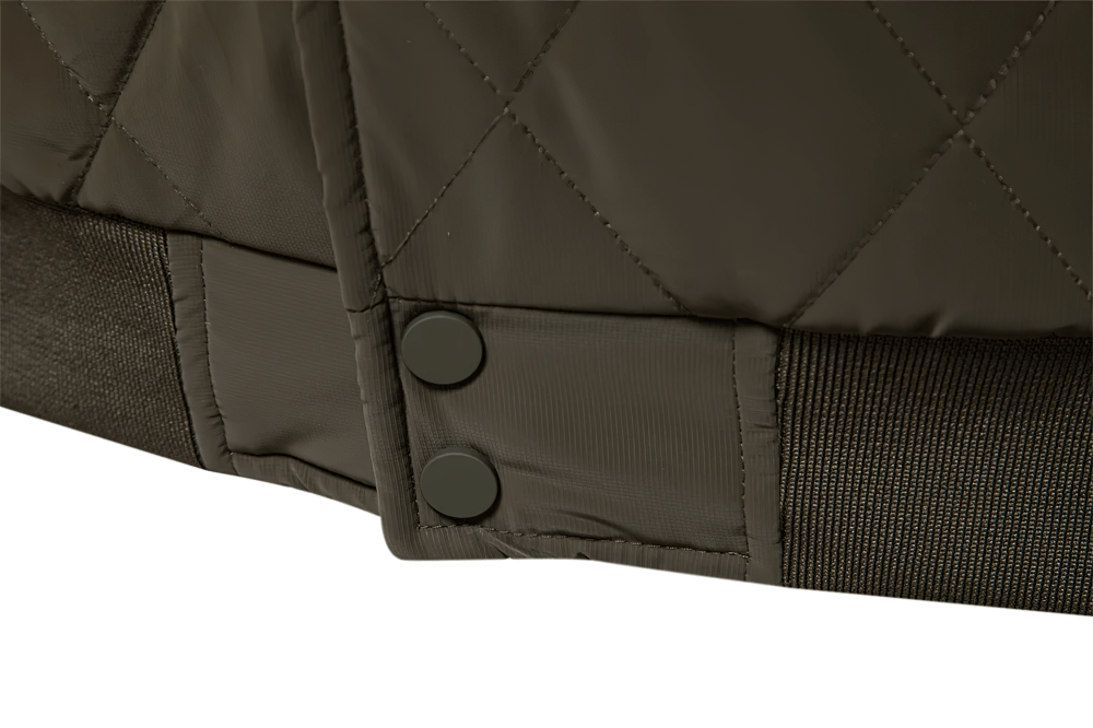 Close-up of snap-button detail on men's patchwork fleece-lined bomber jacket