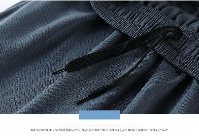 Close-up of elastic waist and drawstrings on men's sporty striped soccer shorts, showcasing comfortable, breathable polyester fabric.