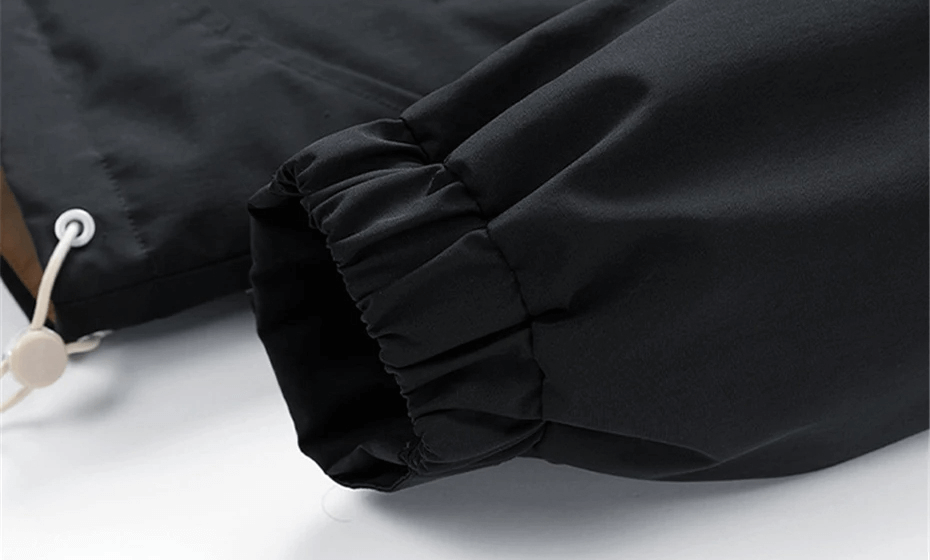 Black sleeve detail of men's puffer jacket with water-resistant fabric and elastic cuff for warmth, from SF2115.