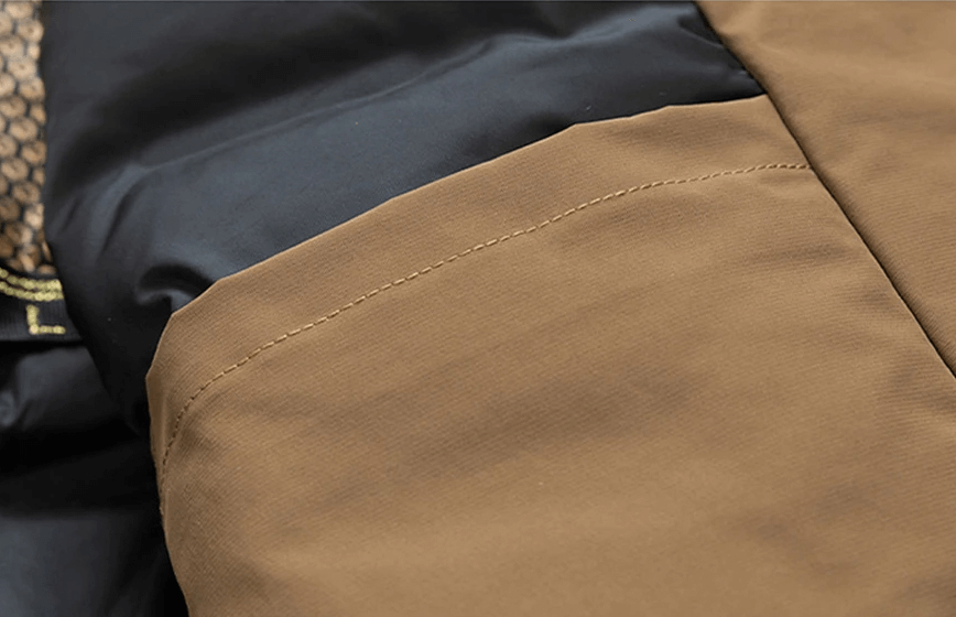 Close-up of the Men's Puffer Jacket SF2115 in brown and black, showcasing its water-resistant, insulated fabric with a stylish finish.