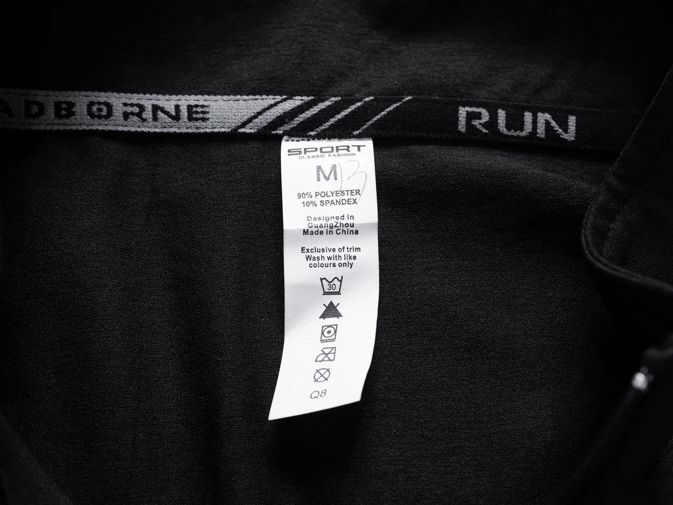 Men's Quarter Zip Running Top with Reflective Trim - SF4589 care label showing fabric details and washing instructions.
