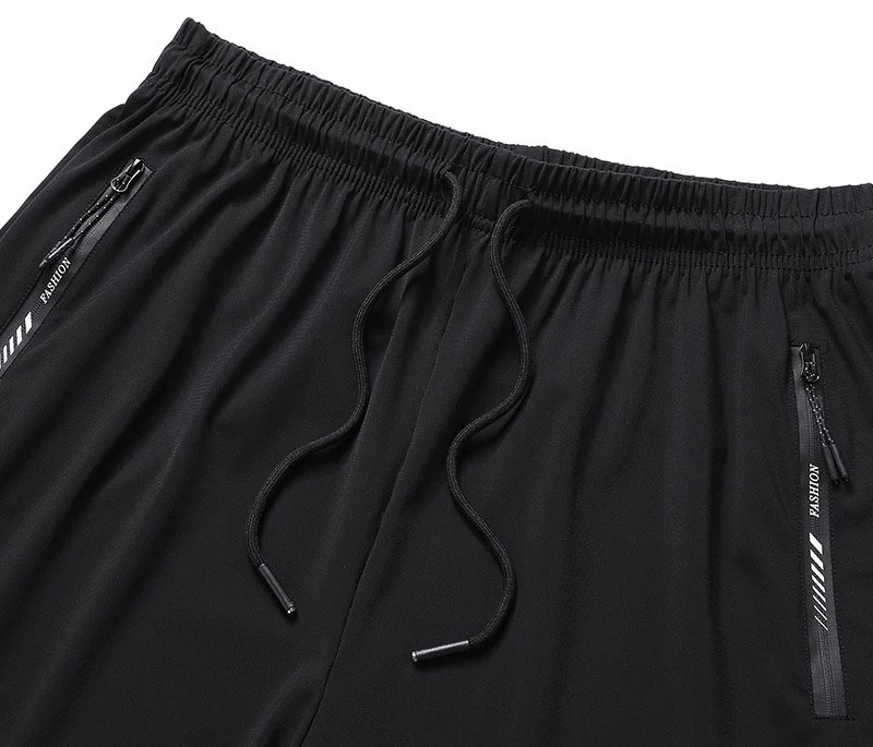 Men's black quick dry athletic shorts with zip pockets and elastic waist, featuring nylon and spandex material for workouts.