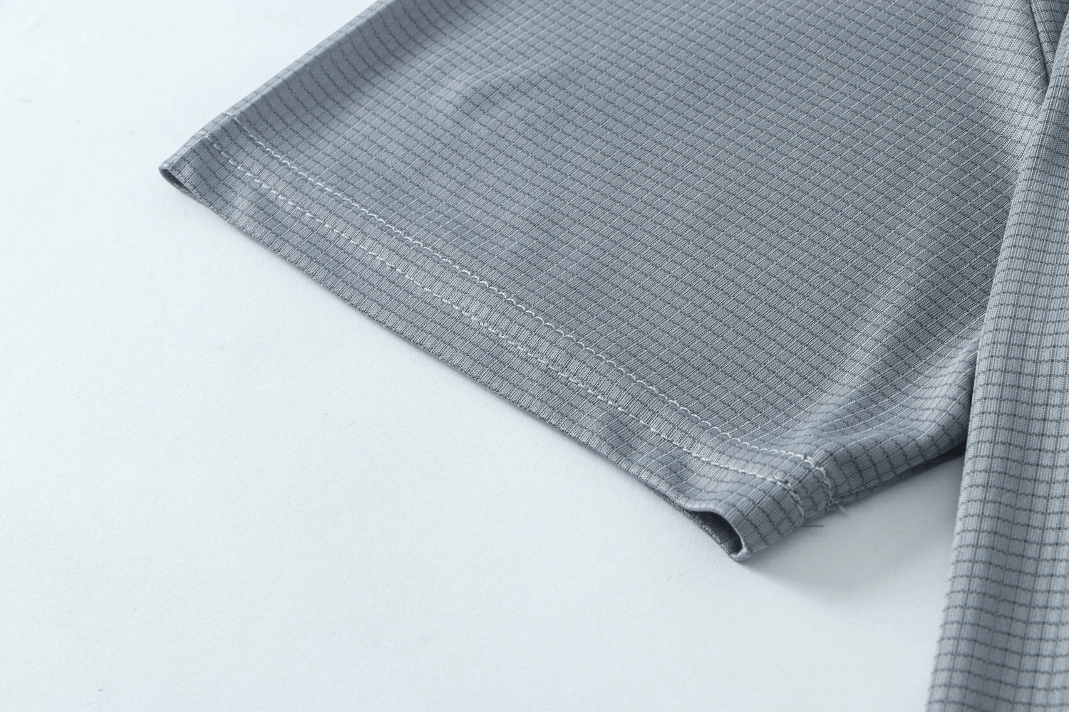 Close-up of gray quick-dry men's t-shirt sleeve, perfect for running and gym workouts.