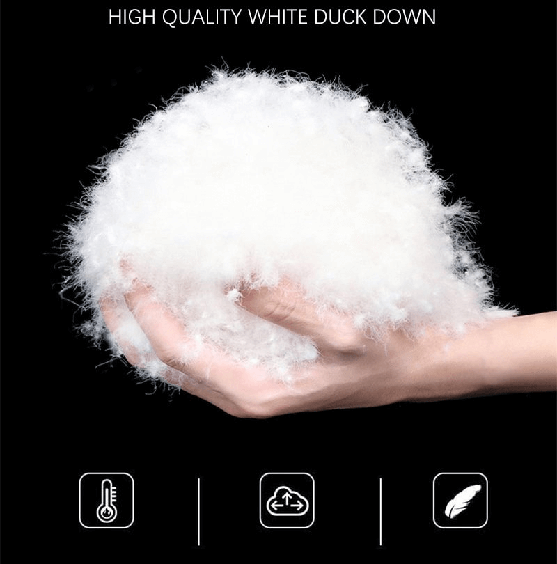 Hand holding fluffy white duck down, highlighting high-quality insulation material for warm down vest.