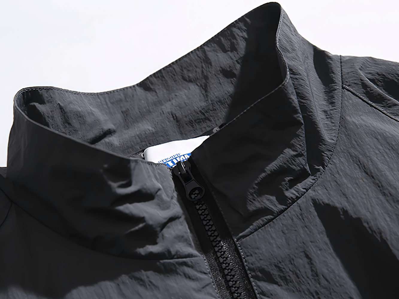 Close-up of Men's Reflective Strip Patchwork Nylon Jacket with a stylish stand collar and zipper, perfect for spring streetwear fashion.