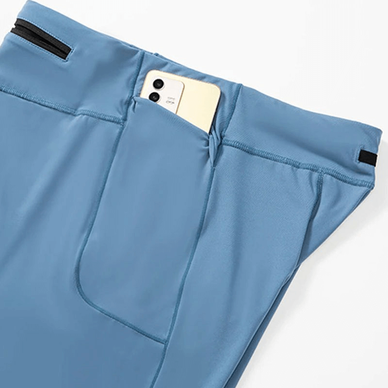 Blue men's running compression shorts with a smartphone in the pocket, made of nylon and spandex for comfort and performance.