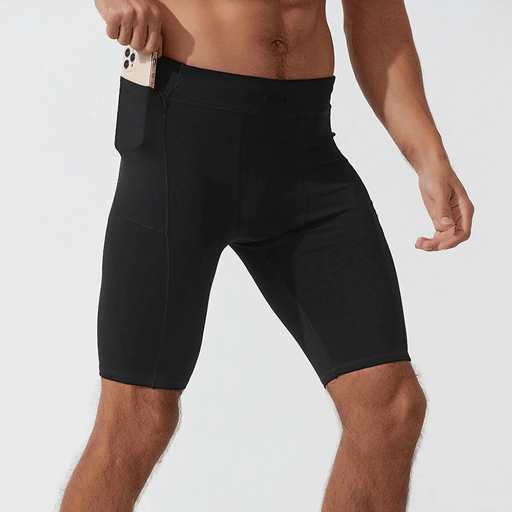 Men's running compression shorts with pockets, made from breathable nylon and spandex, in solid black for stylish workout efficiency.