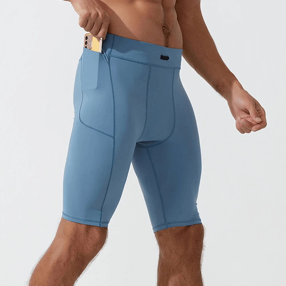 Men's blue running compression shorts with pockets, made of breathable nylon and spandex. Perfect for active workouts and comfort.