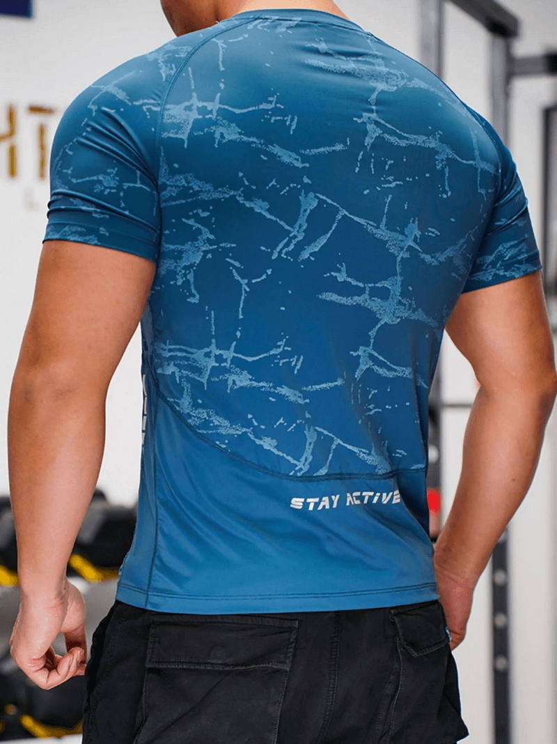 Back view of a man in a blue quick-dry workout tee with stylish print, highlighting the sporty design and breathable fabric.