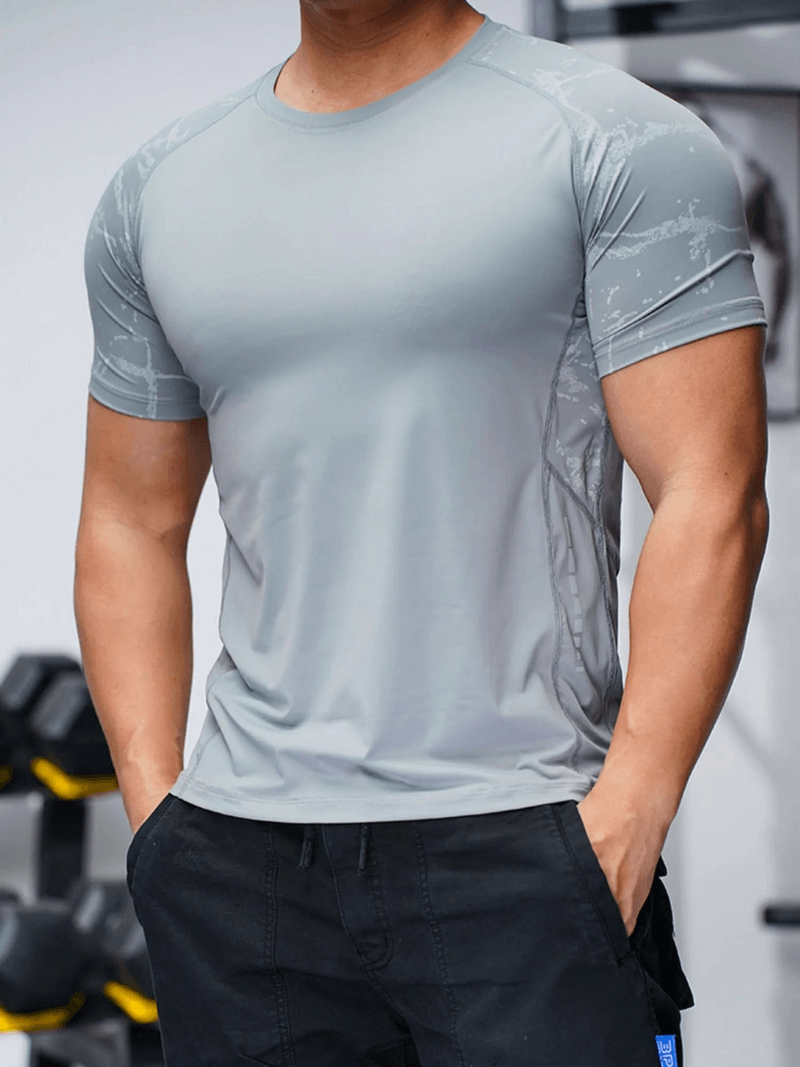 Man wearing grey short-sleeve quick-dry workout tee with print, ideal for fitness, crafted from breathable polyester with O-neck collar.