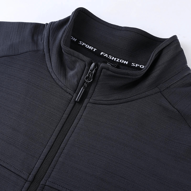 Men's black dry fit running jacket with zipper and stand collar, close-up of top section showing texture and detailing.