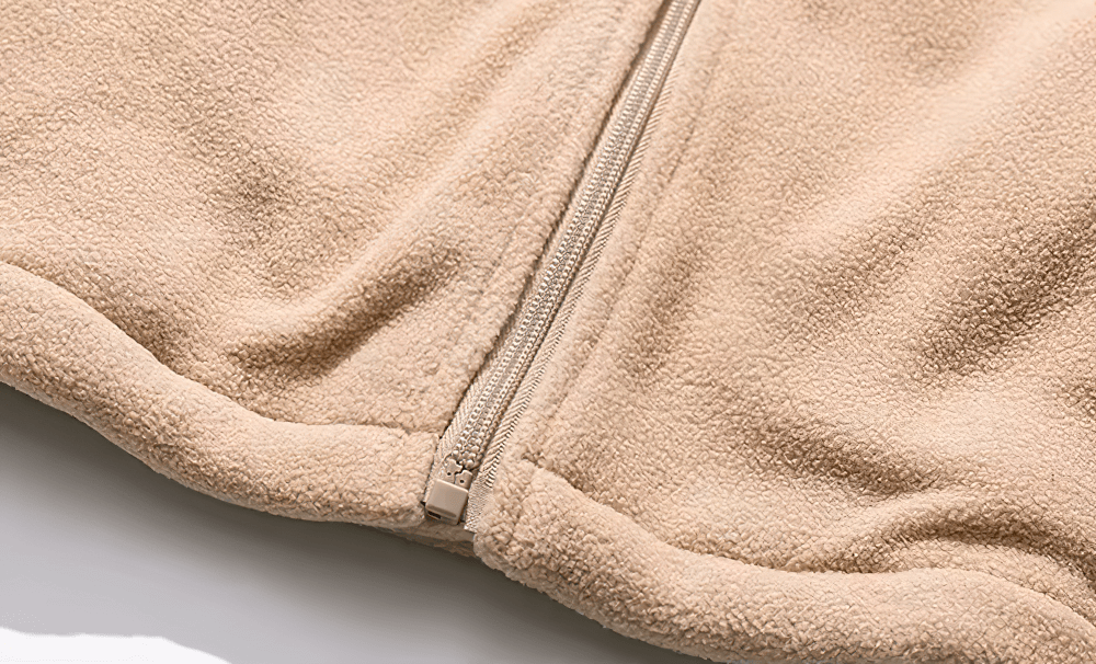 Close-up of Men’s Stand Collar Fleece Jacket with Zipper in beige, showcasing soft polyester fabric and detailed stitching.