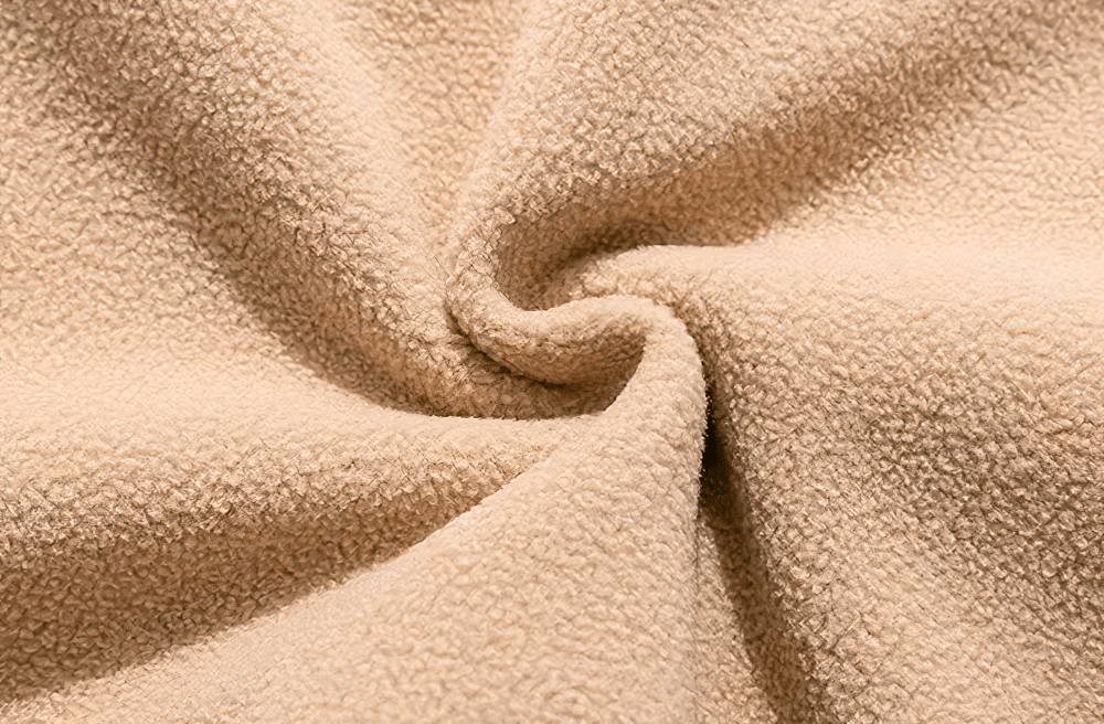 Close-up of soft beige fleece fabric texture, ideal for cozy and stylish streetwear layering.