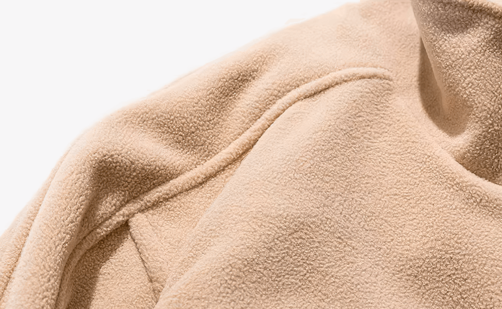 Close-up of beige men's fleece jacket with stand collar, perfect for streetwear fashion. Features soft polyester fabric and minimal design.