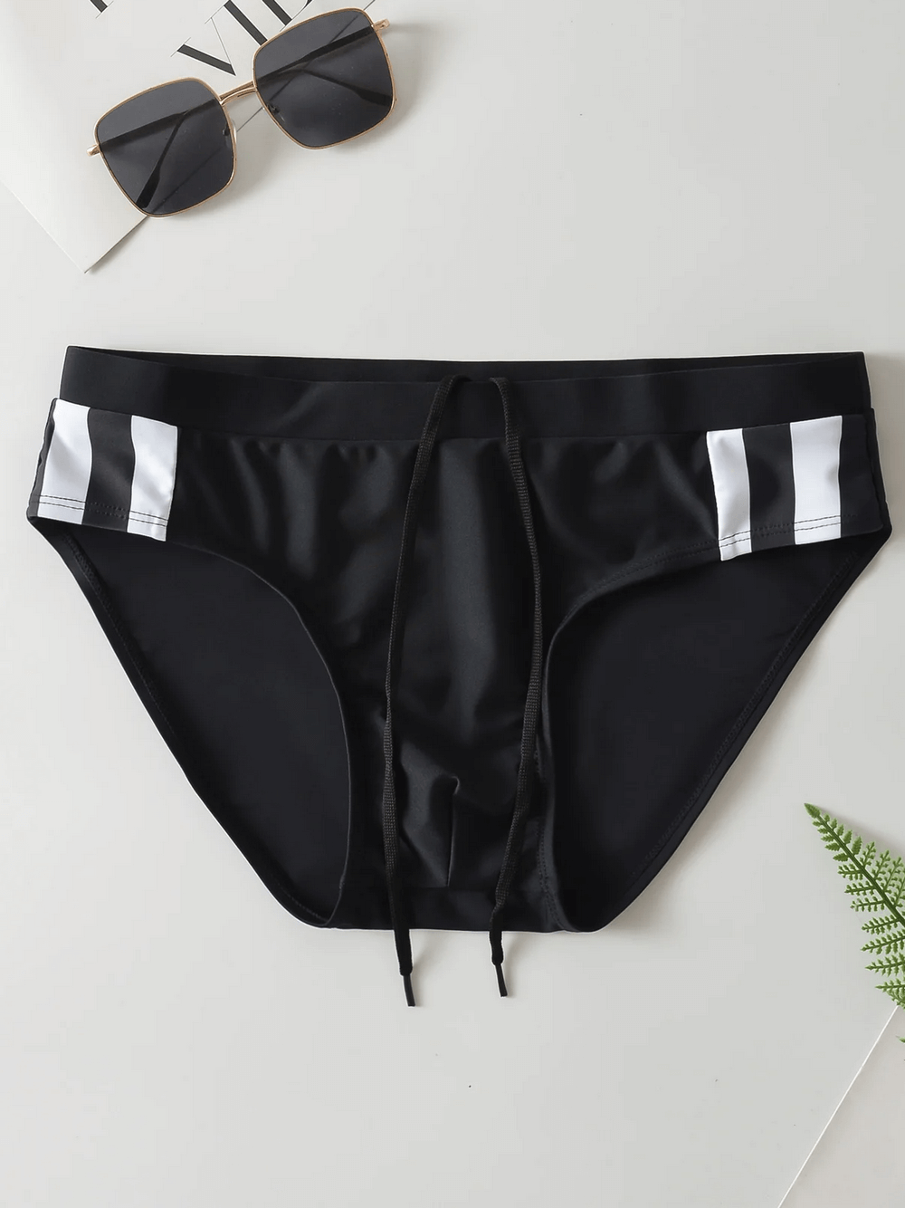 Stylish black men's swim briefs with drawstring waistband, perfect for beachwear. Mid-rise design for comfort and durability. Model SF2191.