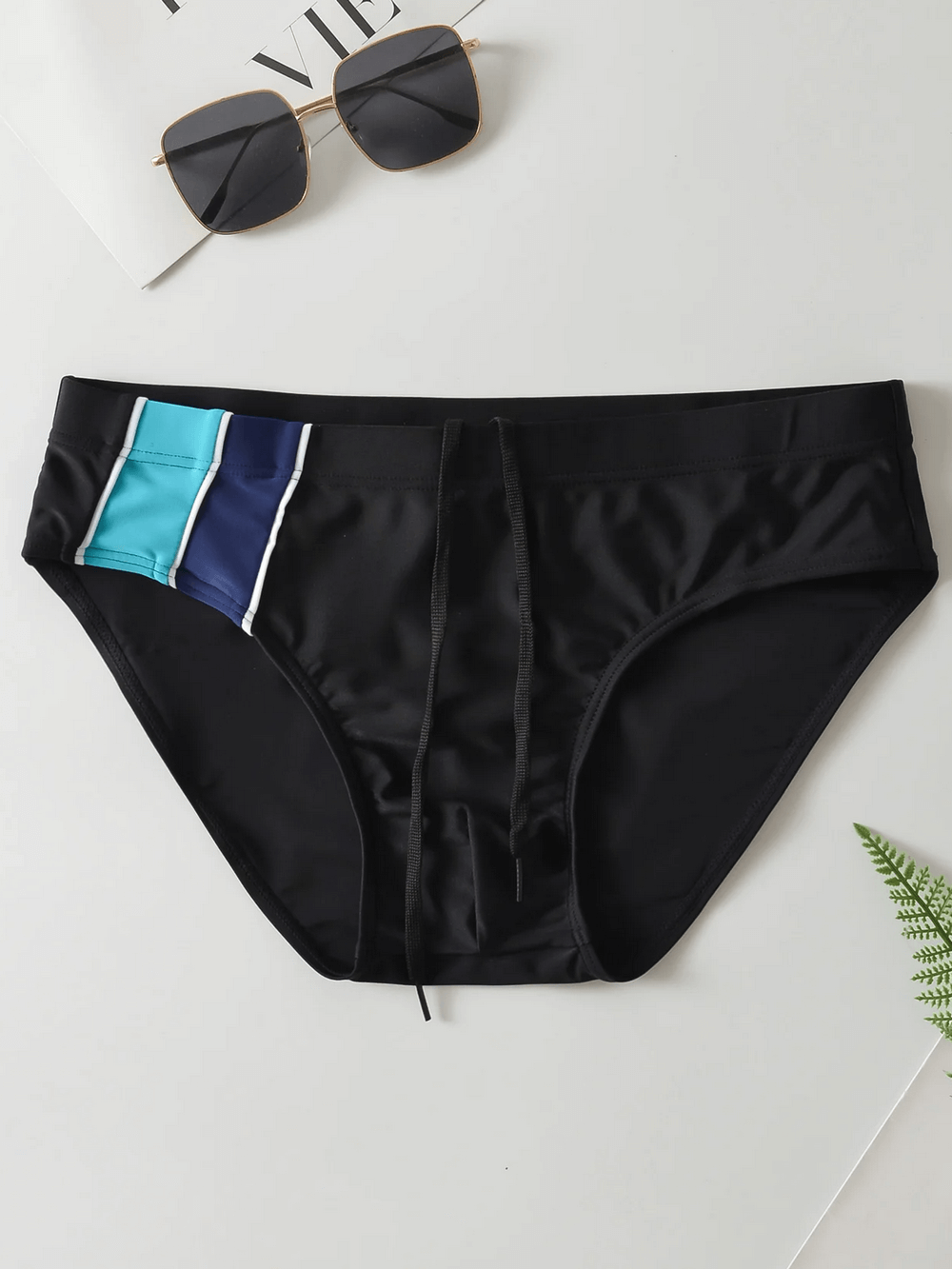 Black men's swim briefs with drawstring and colorful side accents, perfect for beachwear and swimming, stylish and durable design.
