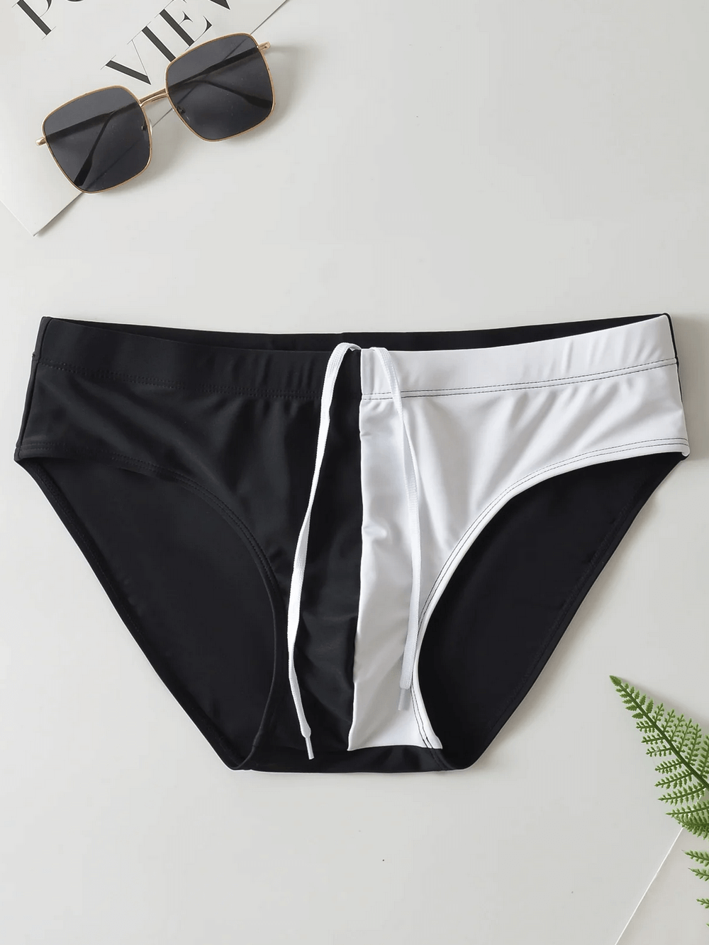 Men's black and white swim briefs with drawstring waistband; perfect beachwear for poolside relaxation and swimming. Model SF2191.
