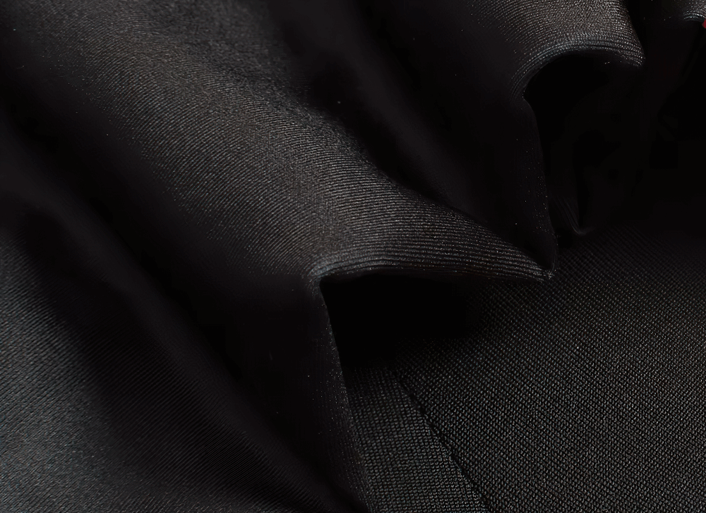 Close-up of black elastic fabric showcasing the durable material used in men's thermal cycling jacket and bib pants set.