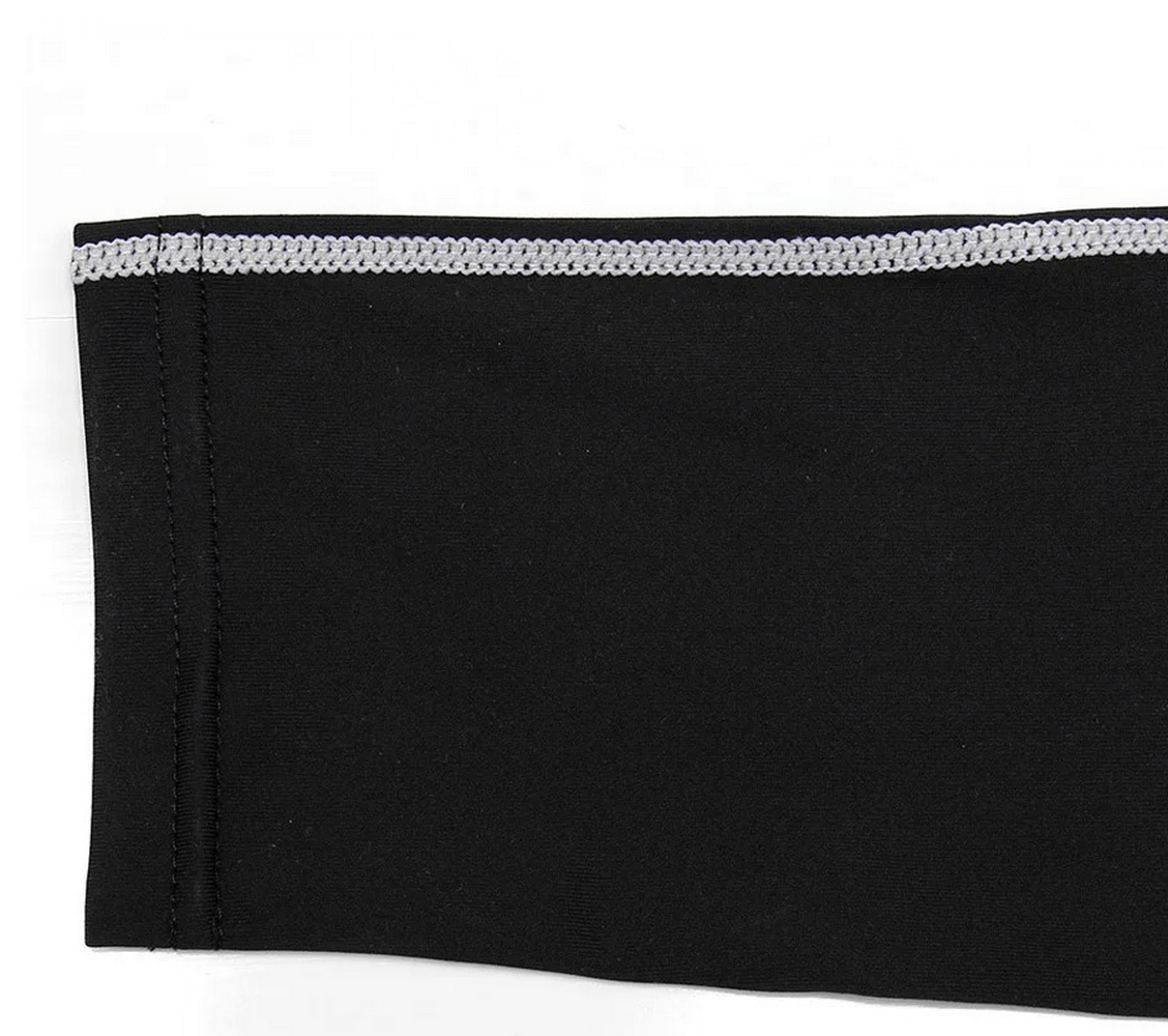 Close-up of men's thermal leggings seam with geo pattern, black with white stitching, made of polyester and spandex.