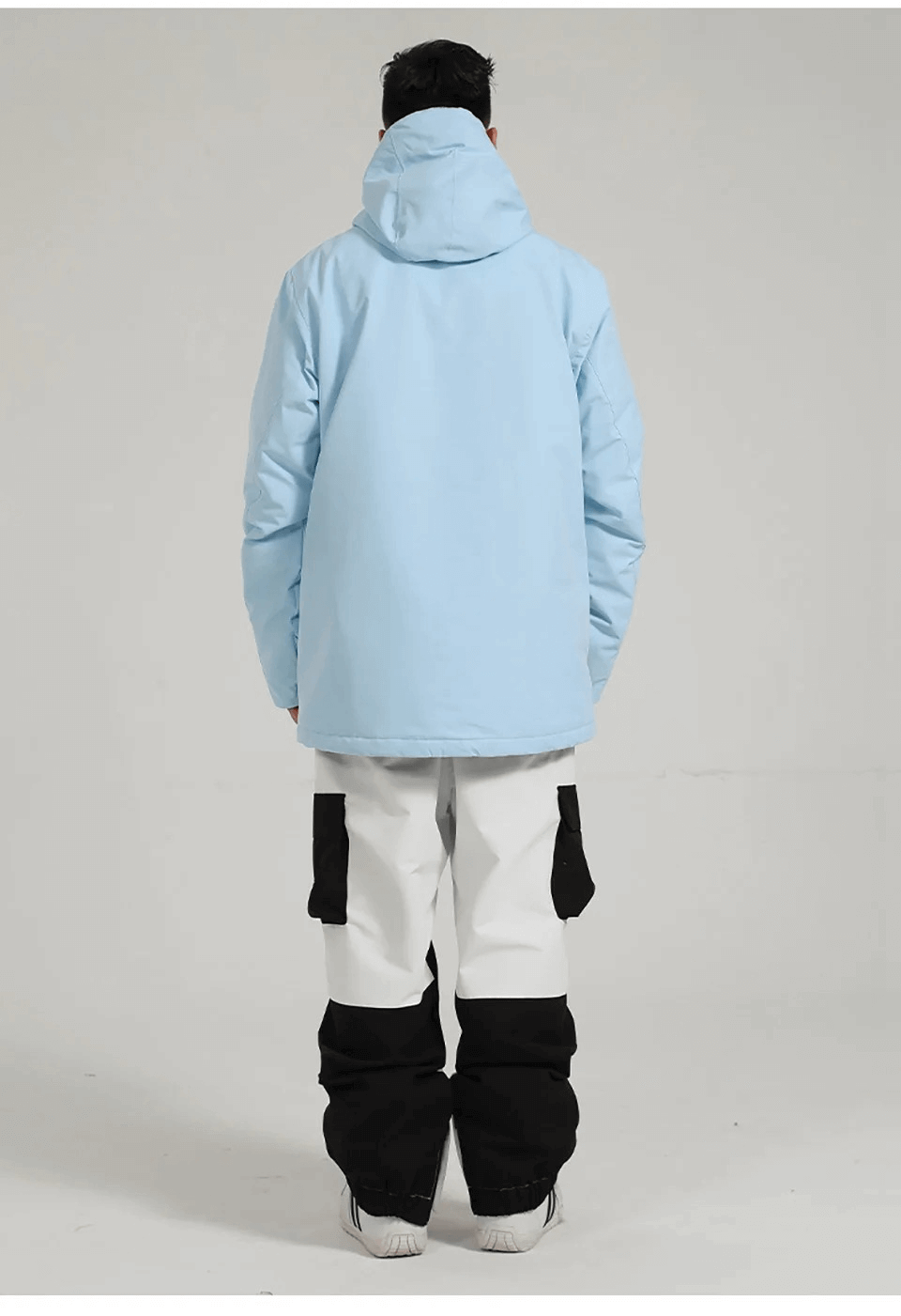 Man in light blue waterproof jacket and black-and-white pants for snow sports. Features include anti-pilling, shrink-resistant, and breathable fabric.