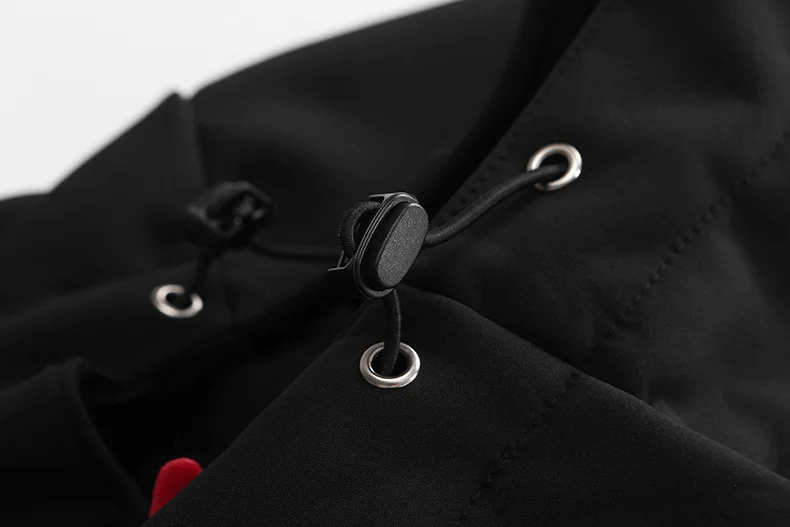 Close-up of black waterproof jacket hood drawstring from men's outdoor sportswear.