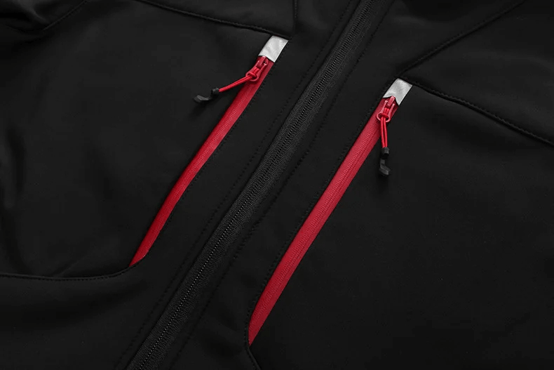Close-up of men's waterproof softshell jacket SF2063, featuring red zippered pockets against a sleek black fabric.