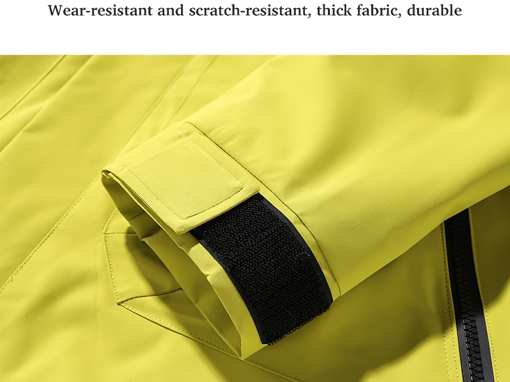 Close-up of a yellow windbreaker's sleeve with a velcro strap, showcasing its wear-resistant, water-resistant, and durable fabric.