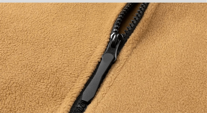 Close-up of zipper on men's windproof fleece jacket, showcasing durable polyester fabric.