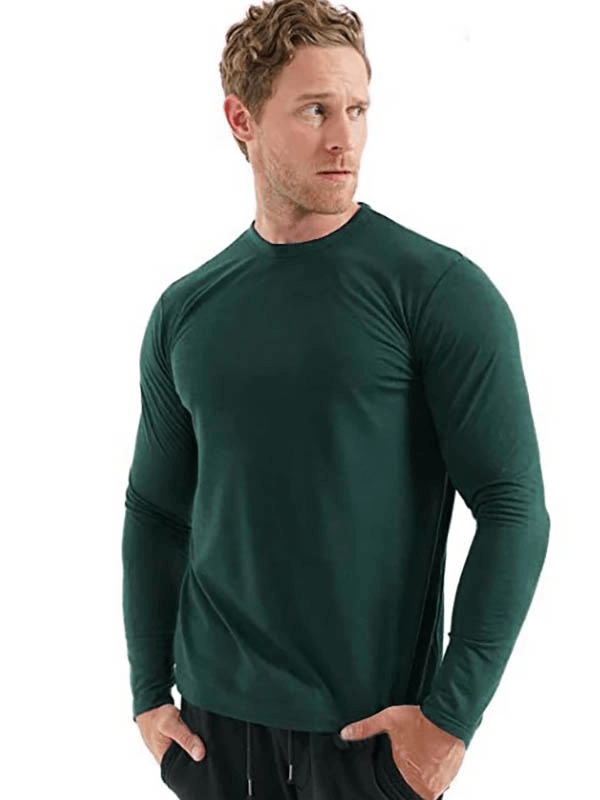 Man wearing a green merino wool thermal long sleeves top, showcasing breathable and warm fabric, perfect for men seeking comfort and style.