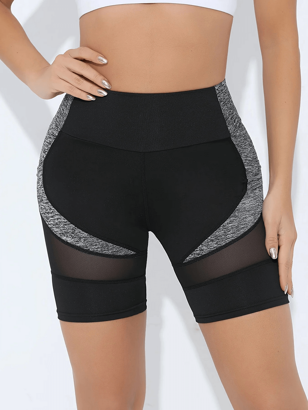 Woman wearing Mesh Activewear Shorts for Fitness and Yoga - SF4114 with crossover waist and breathable mesh panels.