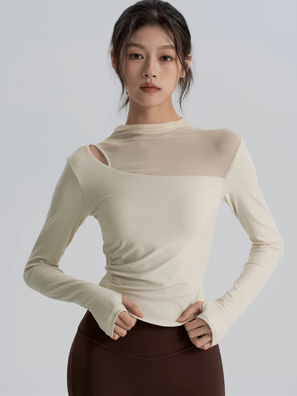 Woman wearing Mesh Back Long Sleeve Yoga Top with Chest Pad - SF4216, showcasing modern workout fashion.