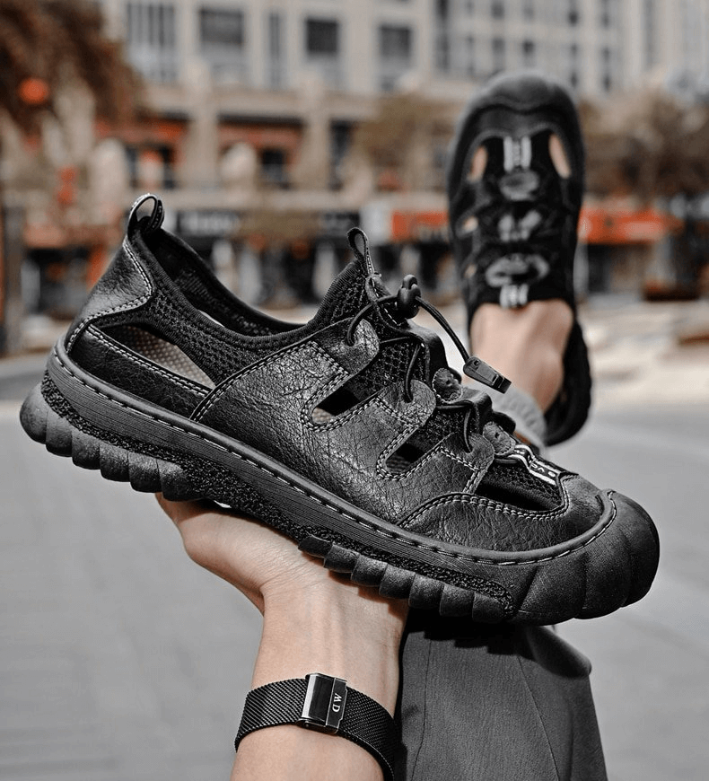 Man holding mesh breathable men's sandals with flexible sole and rubber grip, highlighting lightweight leather design - SF1417