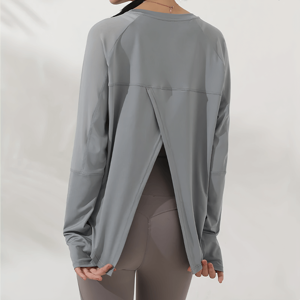 Back view of grey forked-back long sleeve yoga top with mesh panels for women, perfect for gym workouts and autumn runs.