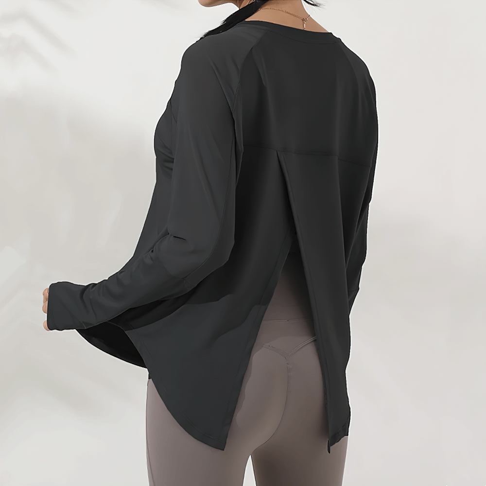 Back view of breathable mesh panel yoga top for women with forked design, long sleeves, and relaxed fit, perfect for workouts.