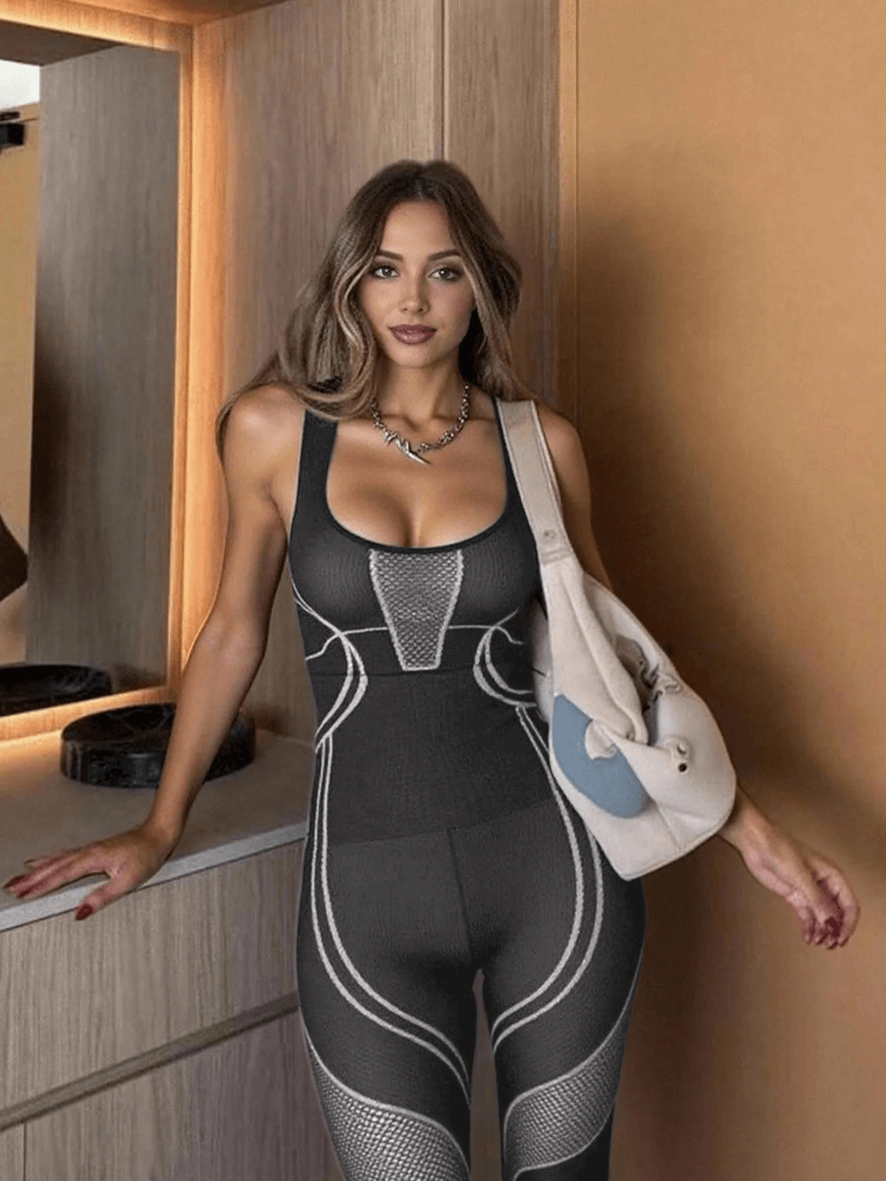 Woman wearing Mesh Panel Yoga Jumpsuit with Sculpt Fit Design - SF4229 in gym, showcasing sporty style and stretch fit.