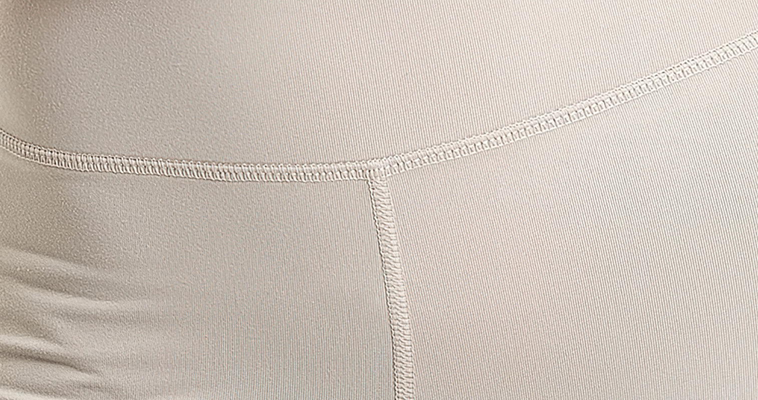 Close-up of beige colorblock leggings showing detailed stitching, part of the chic activewear set for women.