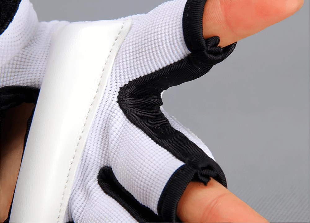 Close-up of MMA sparring gloves SF2687 with EVA pads, showcasing open palm design for flexibility and breathable material.